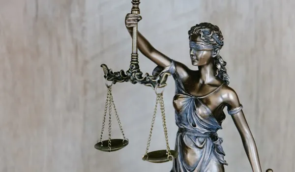 Bronze statue of Lady Justice holding a set of scales